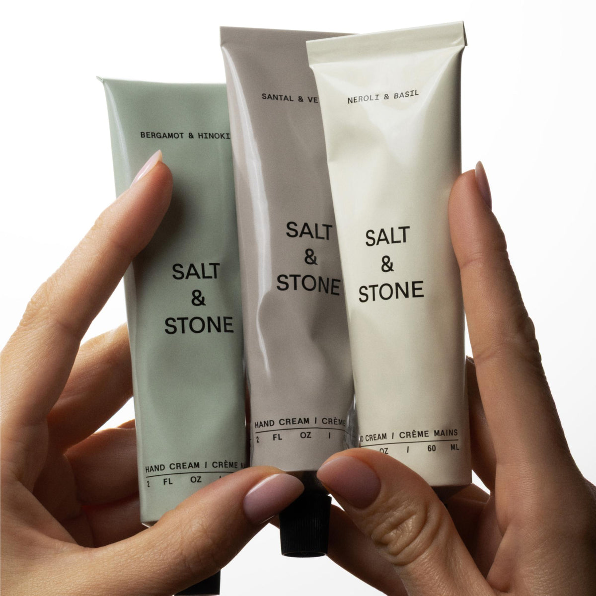 Salt & Stone Handcreme - Santal & Vetiver, 60ml – drei Handcremes der Linie in der Hand
