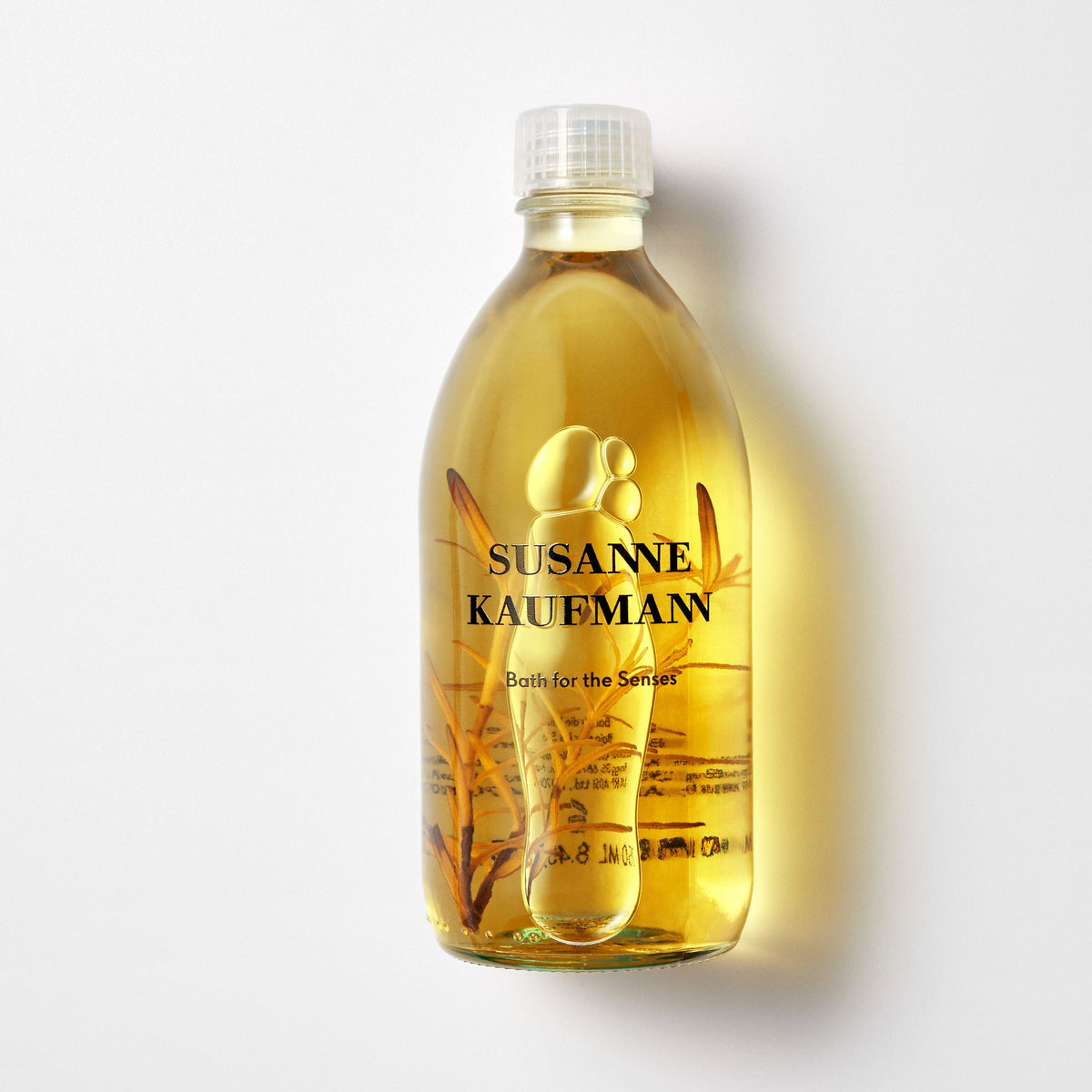 Susanne Kaufmann Bath for the Senses / Bad für die Sinne, 250ml – Flasche mit Pflanzenzweig im Licht