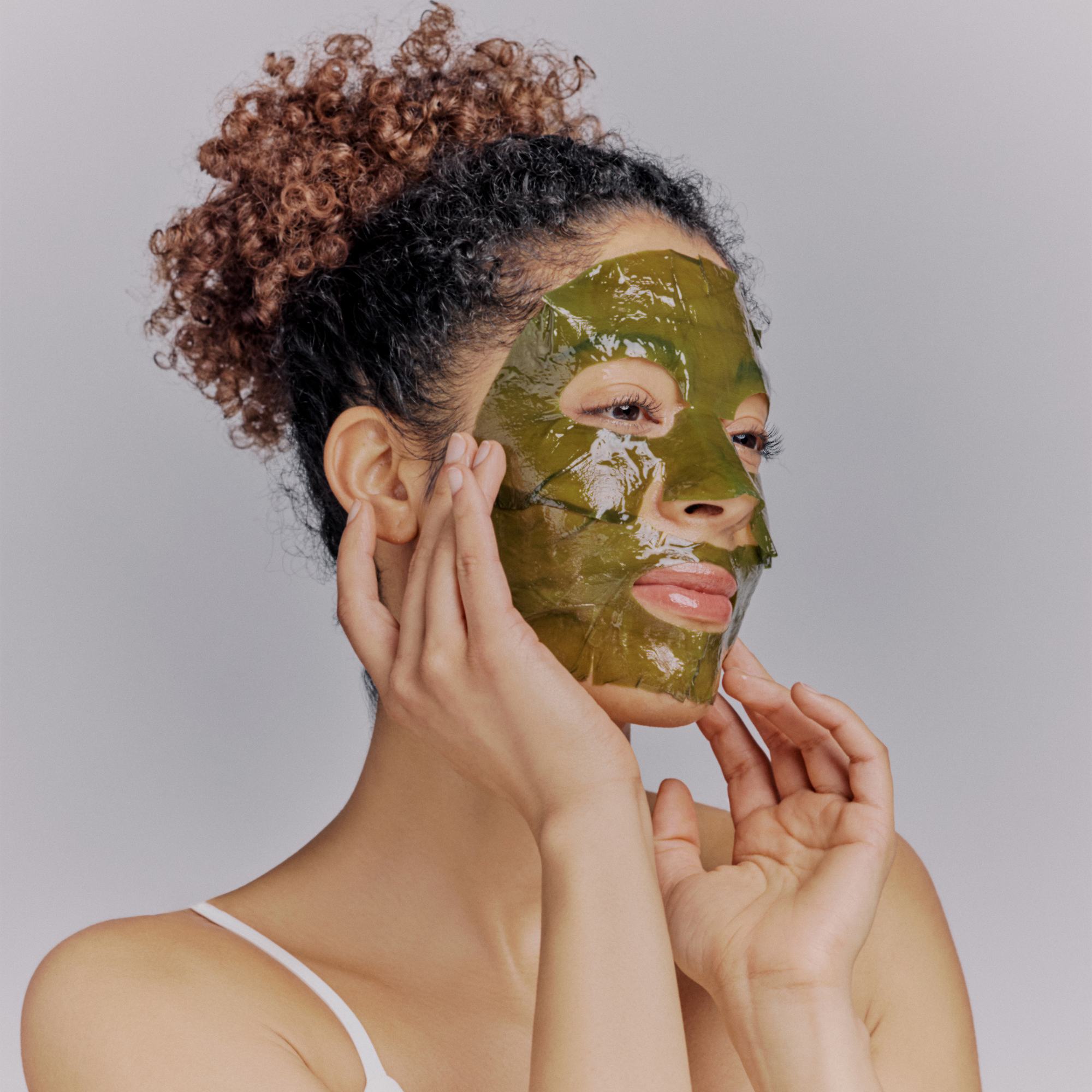 Frau trägt die zweiteilige Algae Kelp Mask auf Augen- und Mundpartie auf